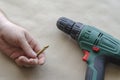 Man`s hand holds a broken drill for metal