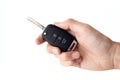 A man's hand holds the car key isolated on a white background close up Royalty Free Stock Photo