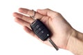 A man's hand holds the car key isolated on a white background close up. Royalty Free Stock Photo