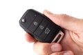 A man's hand holds the car key isolated on a white background. Royalty Free Stock Photo