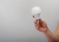 Man`s hand holds energy saving light bulb Royalty Free Stock Photo