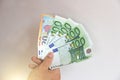 The man`s hand holds the 100 euro, considers them and pays. Pape Royalty Free Stock Photo