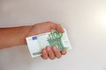 The man`s hand holds the 100 euro, considers them and pays. Pape Royalty Free Stock Photo