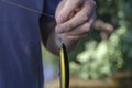 The man`s hand holds a fishing line with a wobbler tied to i Royalty Free Stock Photo