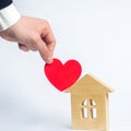 The man`s hand holds the heart and the house . House of lovers. Royalty Free Stock Photo