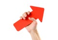 A man`s hand holds a large red arrow. Close up. Isolated on a wh