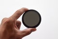 Man's hand holds a ND (neutral density) optical filter