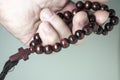 a man's hand holds a rosary Royalty Free Stock Photo