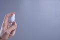 A man`s hand holds and snaps a disinfectant spray to disinfect various surfaces that people touch.antibacterial antiseptic gel fo Royalty Free Stock Photo