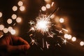 Man`s hand holds sparklers, Happy New Year Royalty Free Stock Photo