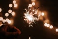 Man`s hand holds sparklers, Happy New Year Royalty Free Stock Photo