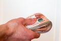 A man`s hand holds a thick wad of cash. Russian rouble. Royalty Free Stock Photo