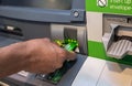 Man's hand inserting a credit card in ATM , Hand inserting ATM plastic card into bank machine to withdraw money Royalty Free Stock Photo