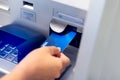 Man`s hand inserting a credit card in ATM , Hand inserting ATM plastic card into bank machine to withdraw money, finance money Royalty Free Stock Photo