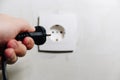 The man`s hand inserts the plug from the socket Royalty Free Stock Photo
