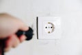 The man`s hand inserts the plug from the socket Royalty Free Stock Photo