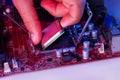 A man`s hand inserts a processor into the motherboard chipset Royalty Free Stock Photo