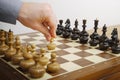 Man's hand making first move in chess game. White starts the chess game Royalty Free Stock Photo