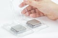 Man`s hand opening a box with a CPU.