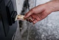 The manÃ¢â¬â¢s hand pays rubles in a machine with a paper Russian bill Royalty Free Stock Photo