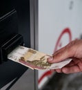 The manÃ¢â¬â¢s hand pays rubles in a machine with a paper Russian bill Royalty Free Stock Photo