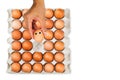 Man`s hand picking up one fresh smiling egg from paper tray Royalty Free Stock Photo