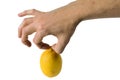 A man's hand pinching a lemon with two fingers