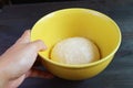 Hand placing a bowl of kneaded dough on the table to let it rises before baking Royalty Free Stock Photo