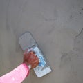 Man's hand plastering a wall