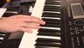 A man`s hand playing electone or keyboard