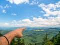 Man`s hand pointing towards the moutains and the blue sky. Beautiful landscape from Piatra Mare Bg Rock mountains, part of the Royalty Free Stock Photo