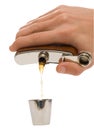 Man's hand pouring a brown liquid into metal cup Royalty Free Stock Photo