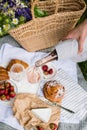 Man`s hand pouring rose wine into glasses, summer picnic