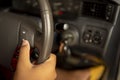 Close up of male hands pushing button on the steering wheel in the car