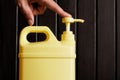 A man`s hand presses a light pump dispenser mounted on a plastic canister with a cleaning disinfectant liquid. Sanitary cleaning