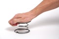 A man`s hand presses on a spring, on a white background.Exert pressure