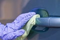 Man`s hand in protective gloves cleaning car door handle using antibacterial or cleaning solution Royalty Free Stock Photo