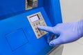 A man`s hand in protective medical gloves dials a pincode at the terminal for issuing money, close-up Royalty Free Stock Photo