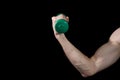 The man`s hand pumps the bicebs. Improve your skills. Hand with dumbbells isolated on black Royalty Free Stock Photo