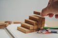 Man`s hand put wooden blocks in the shape of a staircase. Royalty Free Stock Photo