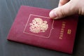 Man`s hand puts international passport. Closeup