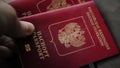 Man`s hand puts two international passports. Closeup