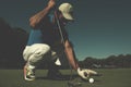 Man`s hand putting golf ball in hole Royalty Free Stock Photo