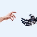 Man`s hand reaches for a robot hand on a light background. Android robot helps a human. Technology concept Royalty Free Stock Photo
