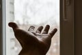 Man`s hand reaches for window. Concept: asking for help, depression, finding way out, freedom, sharing your feelings. Hand