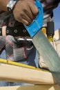 Man's Hand Sawing Plank Of Wood Royalty Free Stock Photo