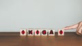 Hand scrolling the letter `I` to combine with the rest of the words to get the word `IKIGAI` on wooden cubes block.