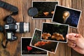 Man`s hand selecting mushroom photos stack and old grunge camera on vintage grunge wooden background Royalty Free Stock Photo