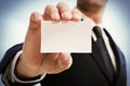 Man's hand showing business card. Black suit and tie. Royalty Free Stock Photo