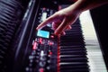 A man`s hand shows on the electronic scoreboard piano Synthesizer stands in the recording Studio. Large white and black keys Royalty Free Stock Photo